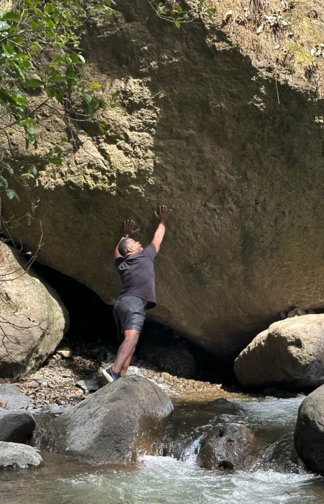 Exploring the boulders and river along the Las Minas Waterfall trail. Photo: Shawn Brooks Photography